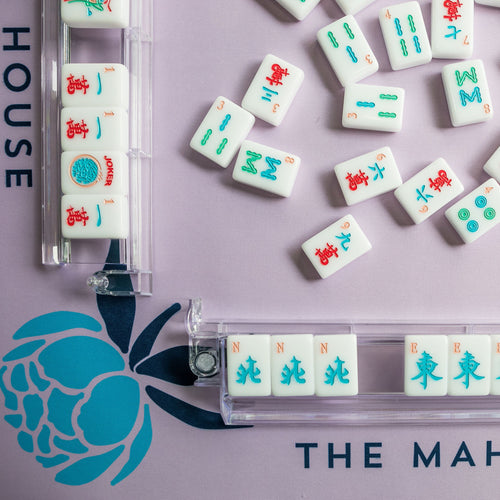 Lavender Mahjong mat with blue peony corner details and “The Mahjong House” logo